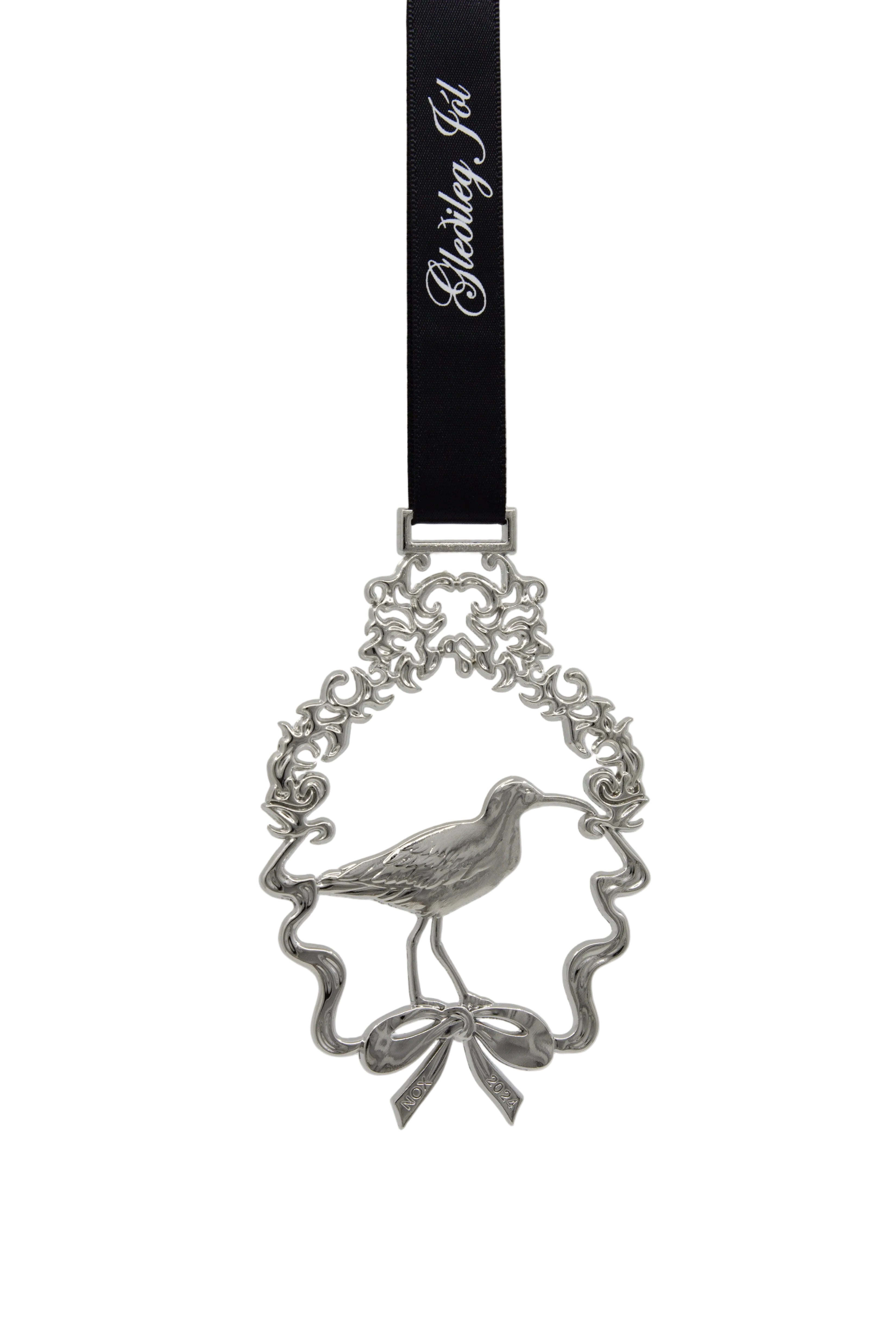 Silver pendant with a bird design on a white background