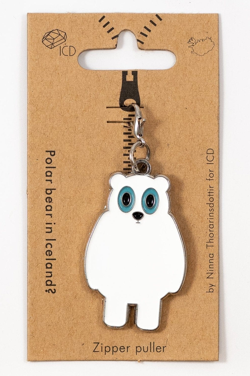 Polar bear zipper pull on a brown card with 'ICD' branding
