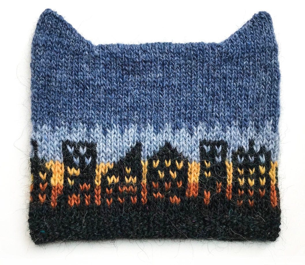 Manhattan Hat laid flat — galaxy brim and buildings with apricot and mimosa windows, an air blue and fjord blue sky, and two little ears at the top