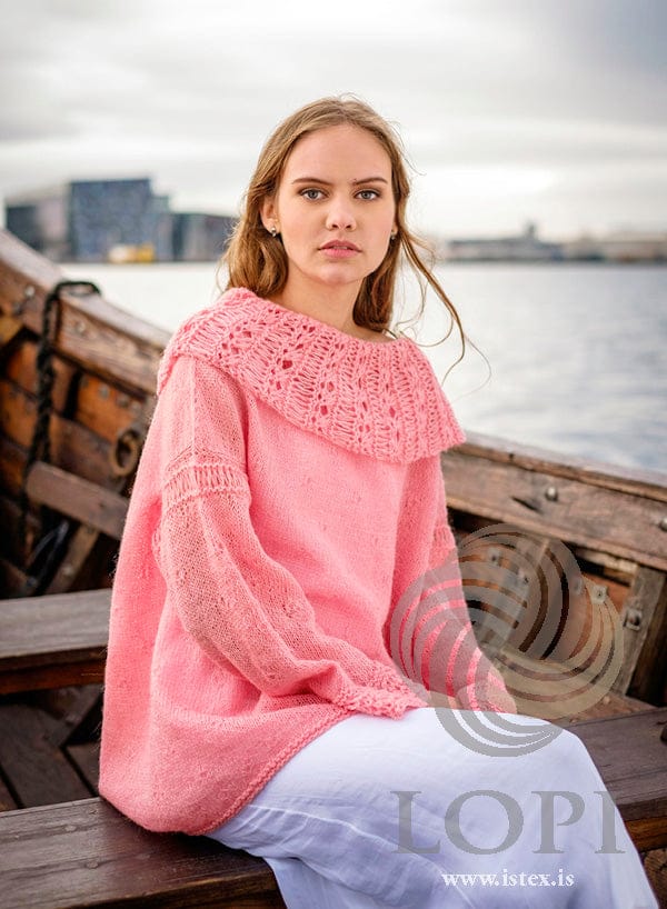 Askja Einband sweater, seated, showing the lace collar and sleeves