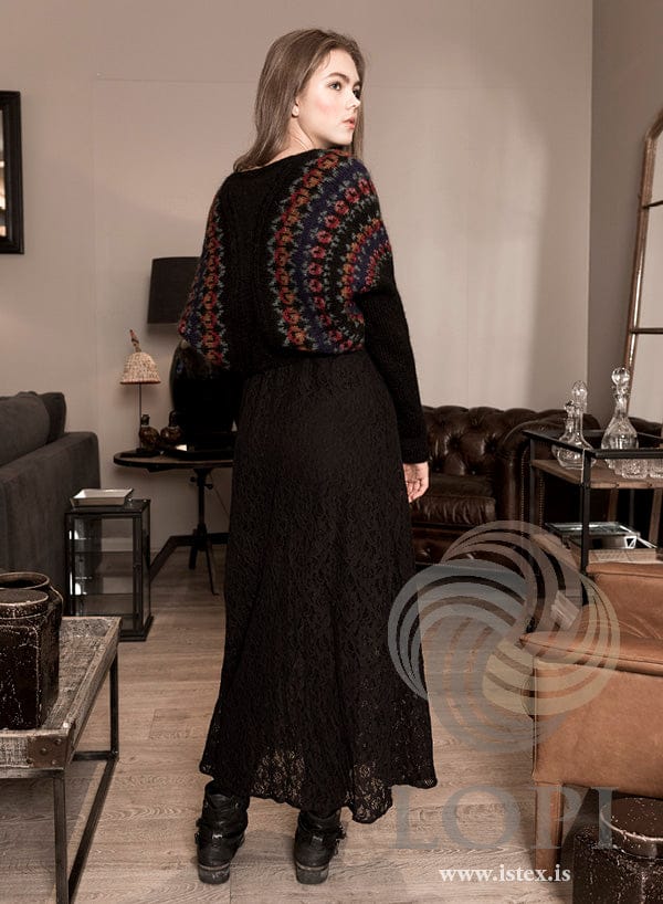 Heartwarmer red-roses shrug worn over a long black dress, from the back (shown in the original colours)