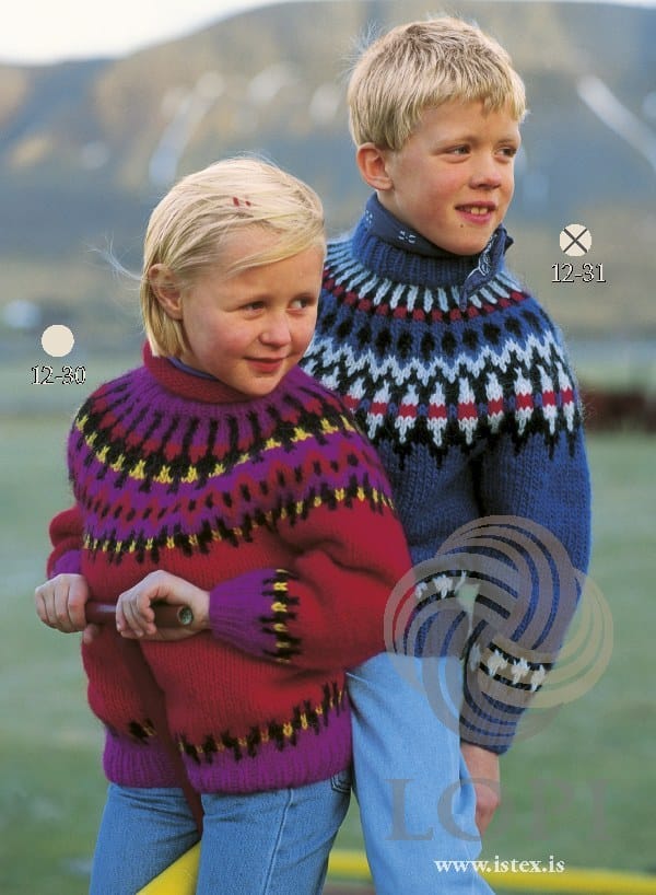 The same sweater in its blue version, No. 31, on the boy marked 12-31 — sold as a separate kit, with two colours replaced. The girl in front, marked 12-30, wears a different Lopi 12 pattern