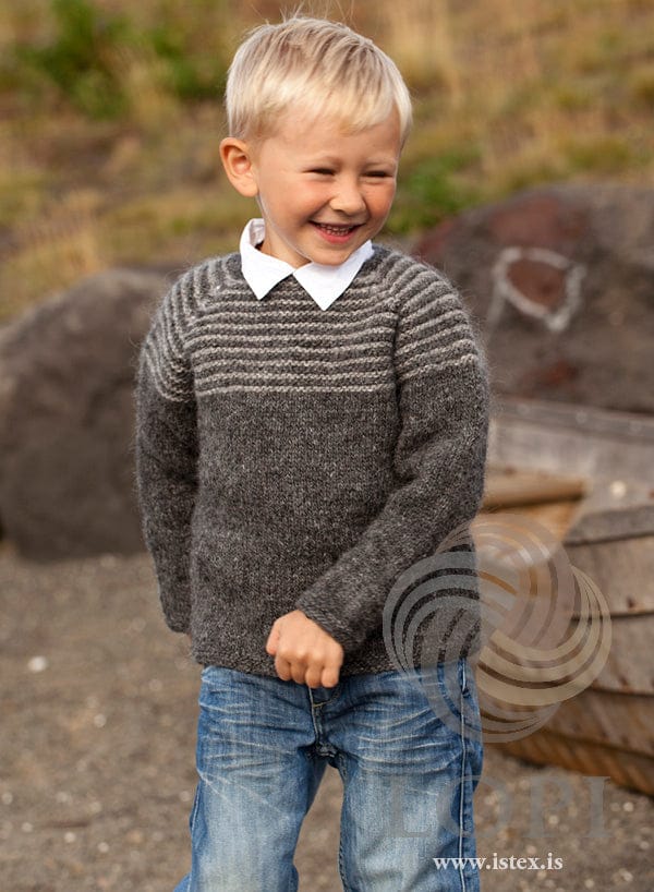 Boy in the two-tone Kjarr sweater — dark grey Léttlopi with an ash-striped garter yoke