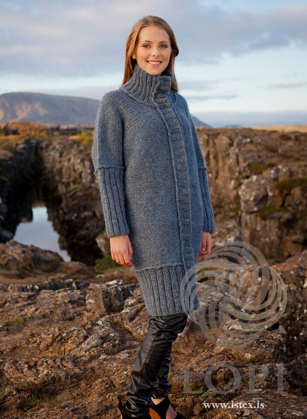 Woman in the Blámi long cardigan — light indigo Álafosslopi with a tall collar and long ribbed cuffs