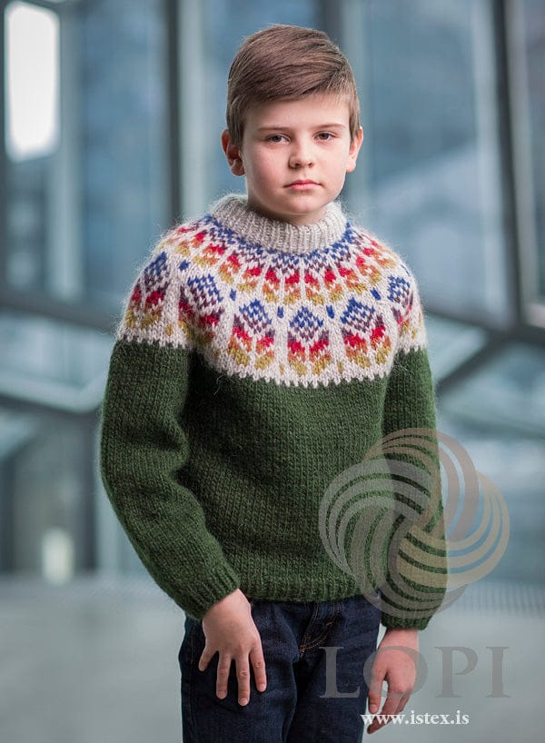 Boy in the Akur sweater — garden green Álafosslopi with a seven-colour yoke on light ash