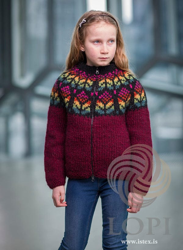 Girl in the Blómey zip cardigan — oxblood red Álafosslopi with a flower yoke in seven colours
