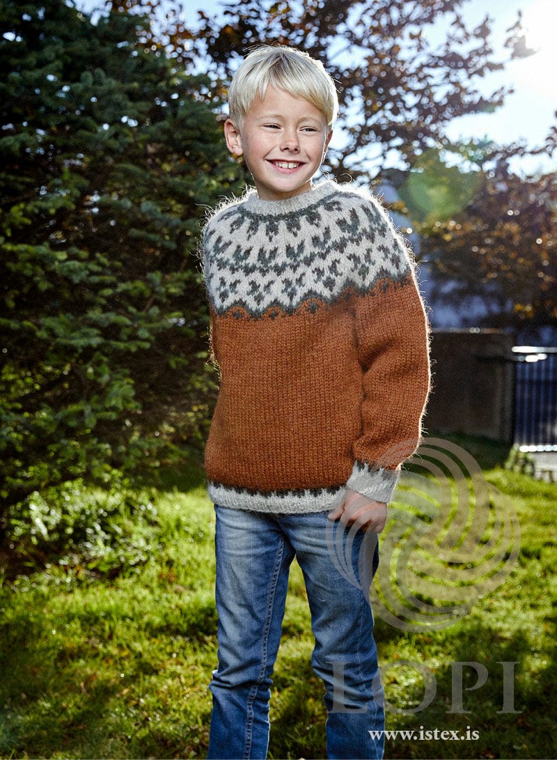 Afleggjari children’s sweater in dark amber Plötulopi with a light ash yoke patterned in green and black sheep (shown in the original colours)