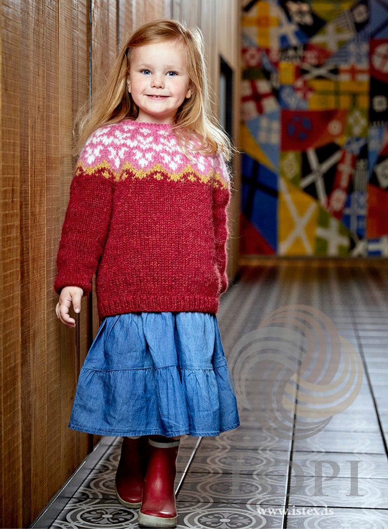 Liljulag children’s yoke sweater in carmine red Plötulopi with a pink yoke of white lilies