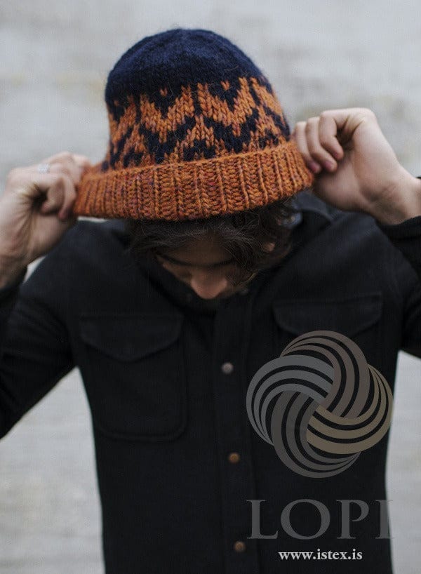 Kalsi hat in Álafosslopi — amber folded brim and a midnight blue and amber pattern