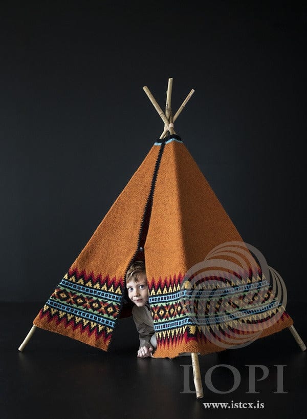 A child peeking out of the Tjald knitted tent