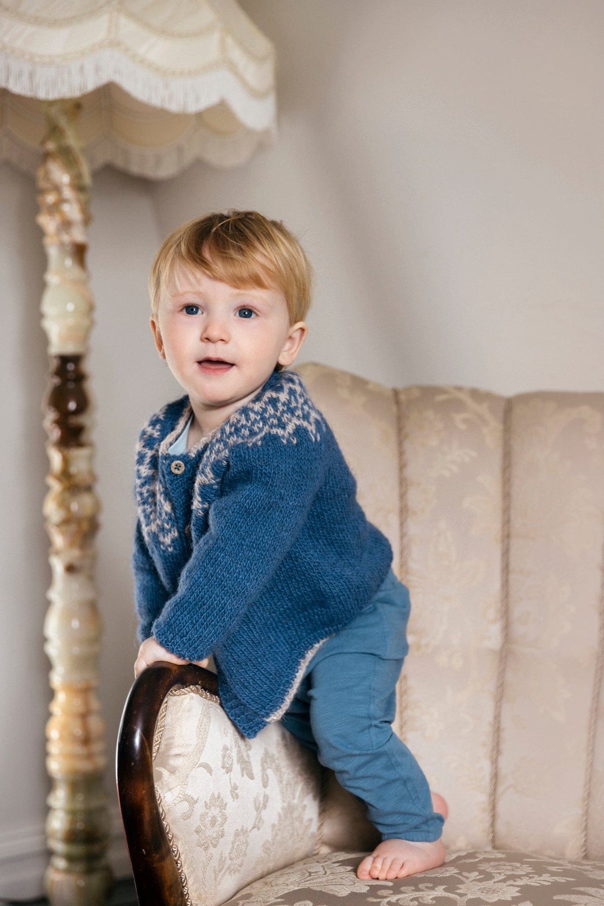 Dagmál baby cardigan in mountain blue Fjallalopi with a light moorit yoke, buttoned