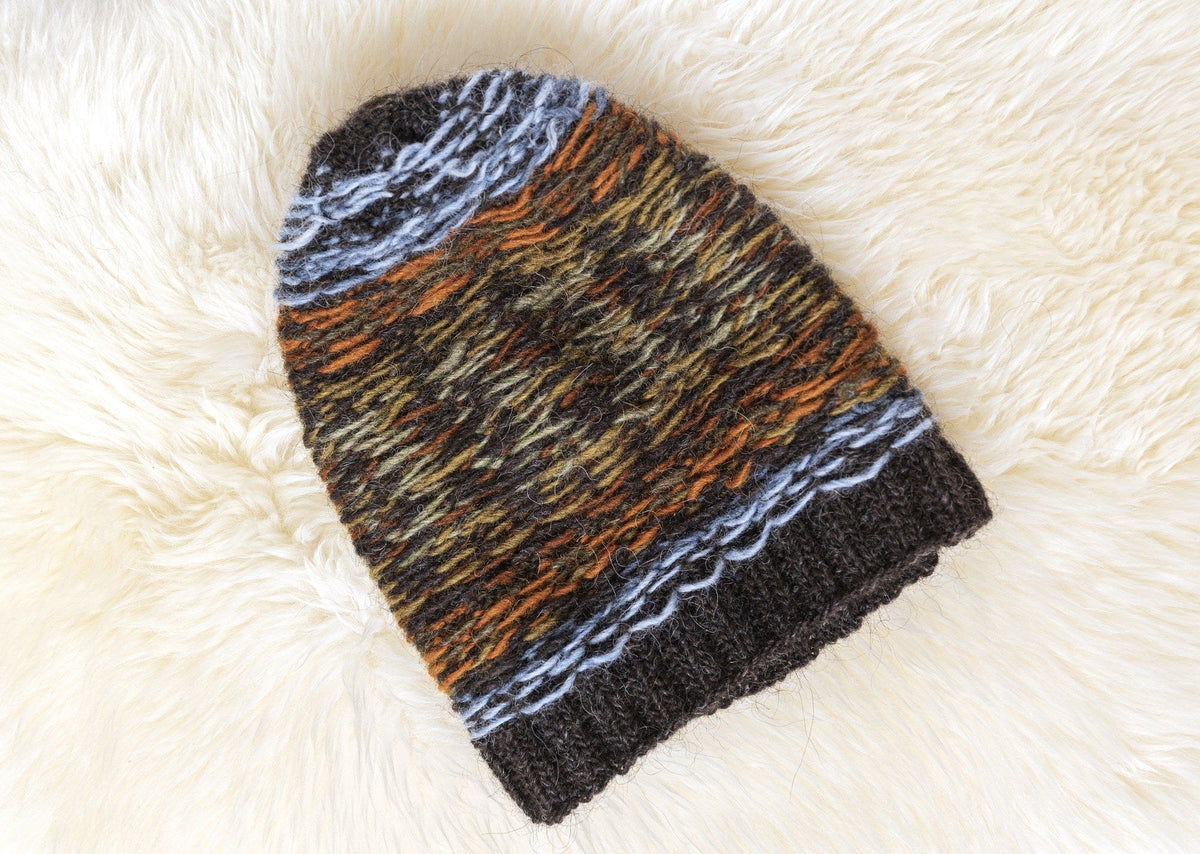 Lofoten Hat turned inside out, showing the carried strands of the eight colours above the plain rib