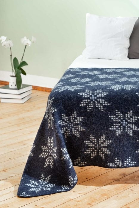 An Icelandic wool blanket with a traditional 8-petalled rose pattern.