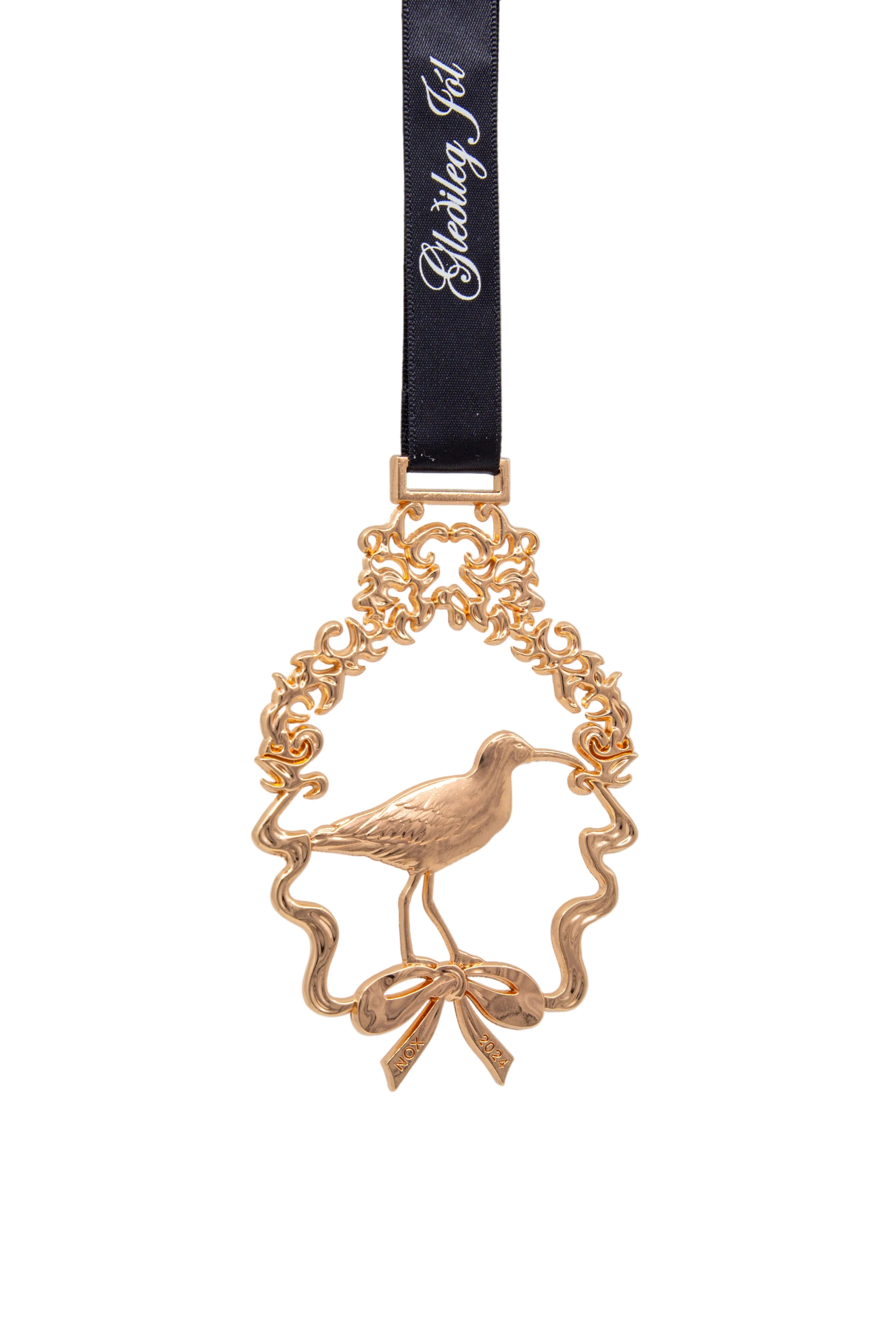 Gold bird ornament with a black ribbon on a light gray background