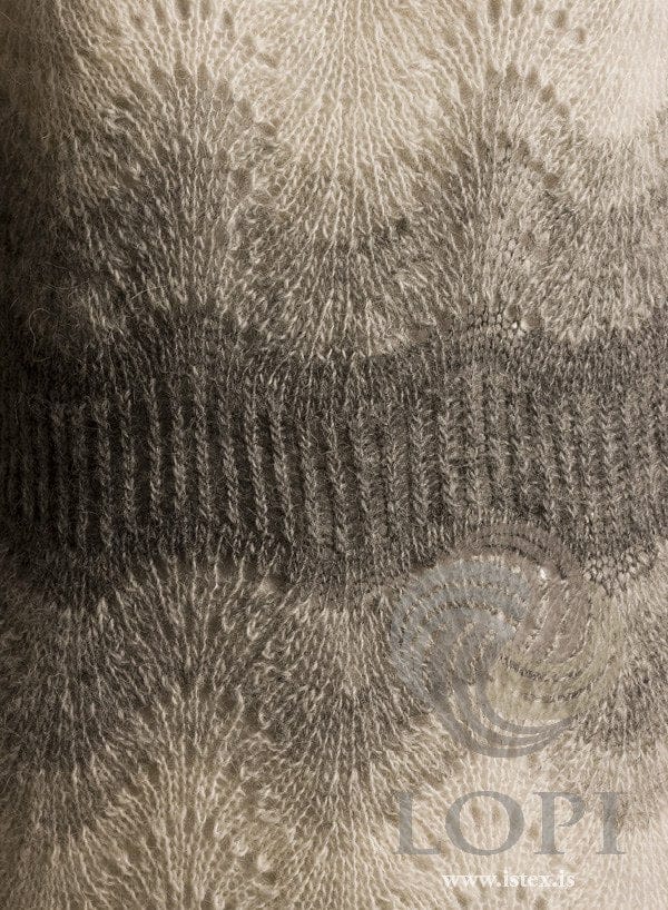 Close-up of the waist of Miðja, the white and grey version — white wave lace above and below, shading through pale and mid grey into the grey twisted-rib waistband, in the pattern’s own colours