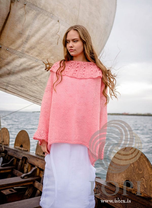 Askja seen at an angle under a sail — the hem hangs lower at the back than at the front — with the deep collar and wide cuffs, in the pattern’s original blush. The long white dress is not part of the pattern