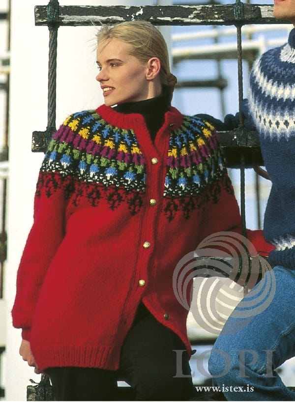 Closer view of the Lopi 12 no. 17 cardigan, buttoned, in the original colours — this kit replaces five of them (see the description). The black polo neck, the black trousers and the gold buttons are not part of the kit; at the right edge are part of the man’s sweater, Lopi 12 no. 19, and his jeans