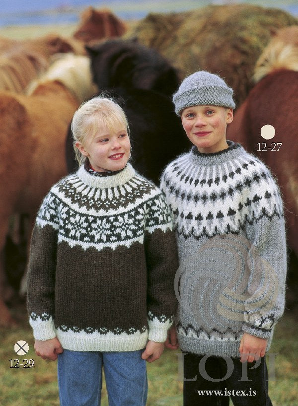 The same pattern in its brown version, No. 29, on the girl on the left — sold as a separate kit. The boy on the right wears Lopi 12 no. 27, a different pattern