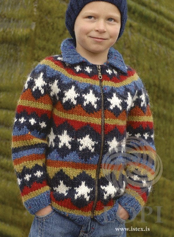 The same Stjörnur pattern in its second colourway, on a boy — white stars in navy diamonds with a blue tweed collar — sold as a separate kit (shown in its original colours; that kit has replacement colours too). The beanie and jeans are not part of the pattern