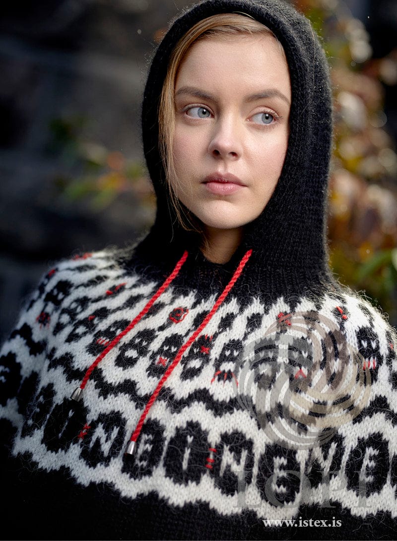 Close view of the NEI! yoke and hood — black letters on white with red embroidery