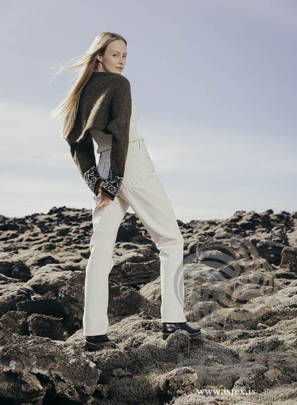 Back view of the moss green Armur shrug — the sleeves joined by a plain back panel