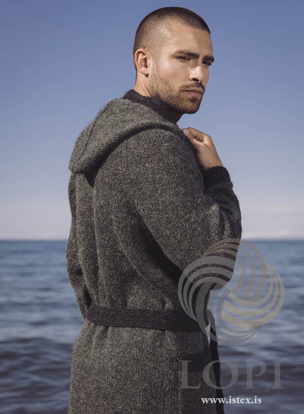 Sær robe with the hood down, showing the black heather seed-stitch front band