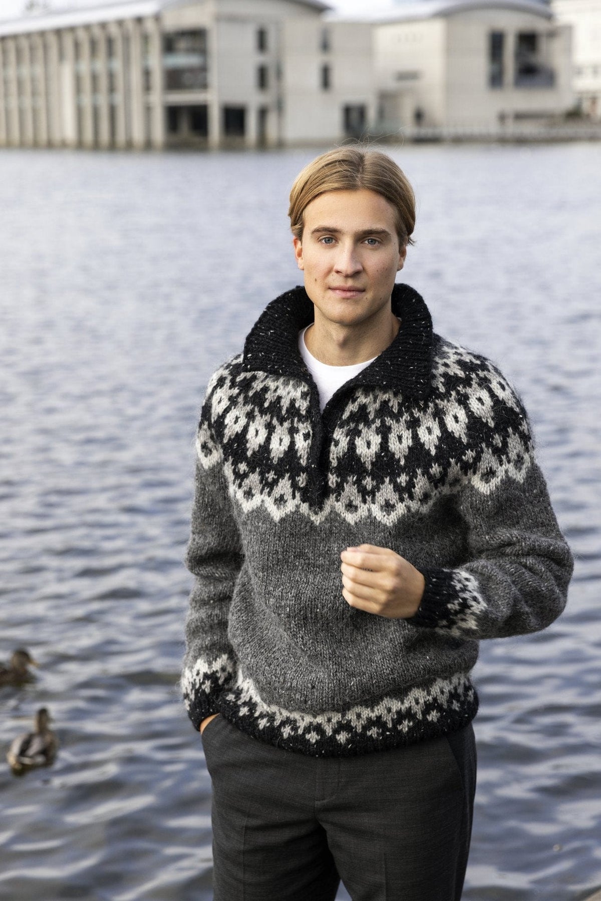 Ýlir Icelandic yoke sweater knitted in Álafosslopi — dark grey with a black and light grey tweed yoke and a collar