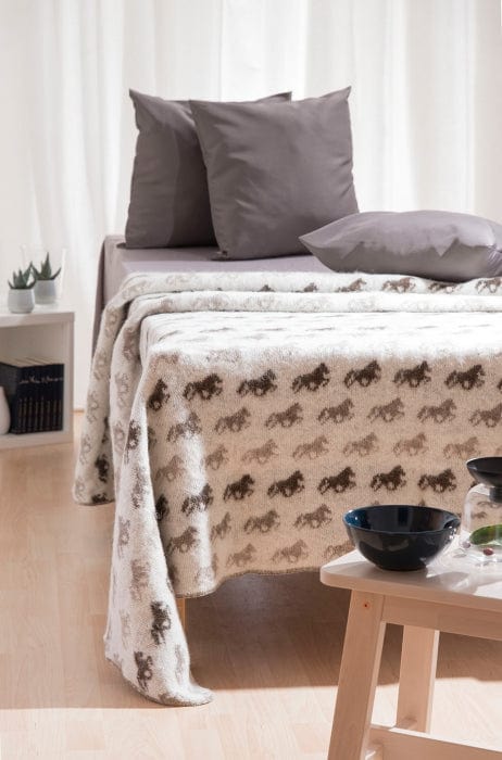 Beige woolen bedspread. Icelandic wool blanket with horses