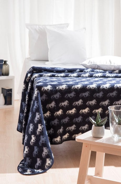 Blue woolen bedspread with horse pattern. Wool blanket from Iceland